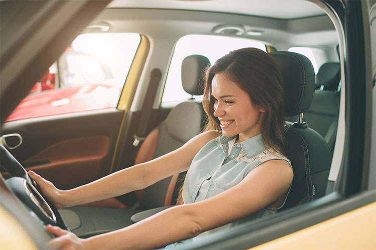 Woman behind wheel of vehicle